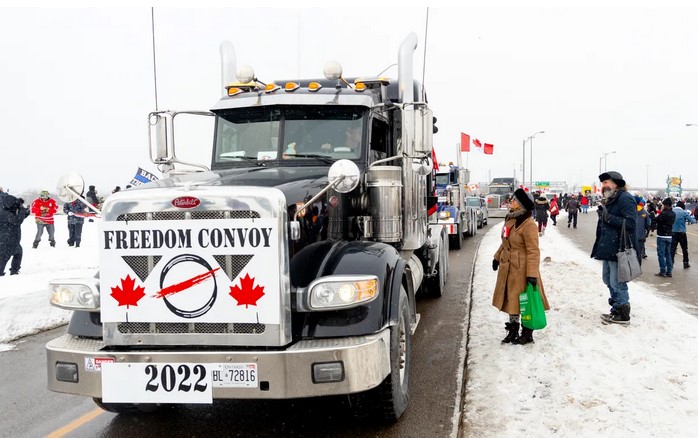 truck with a placard saying 'Freedom Convoy'